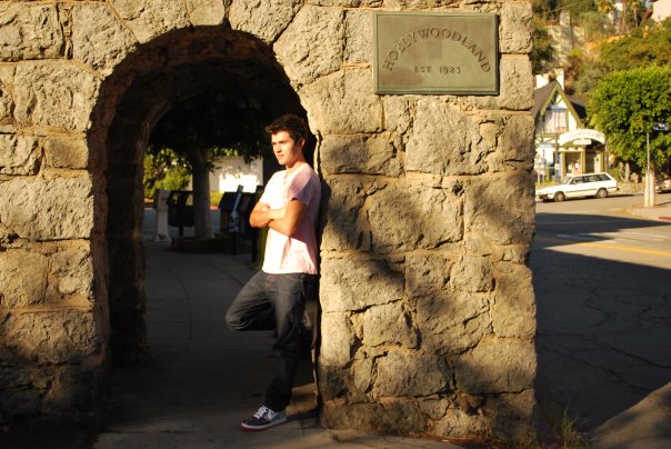 Logan leaning against a wall.